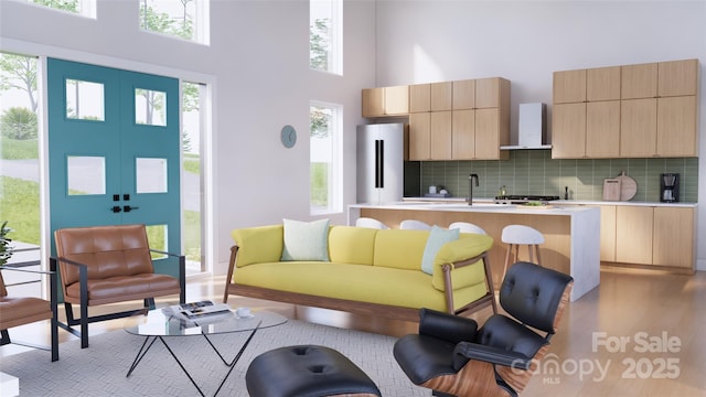 living room with sink and a high ceiling