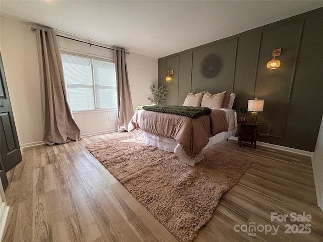 bedroom with hardwood / wood-style floors