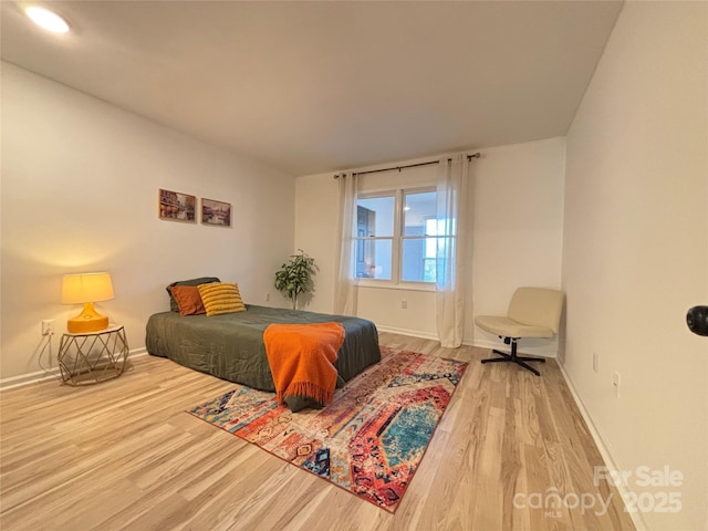 bedroom with hardwood / wood-style flooring