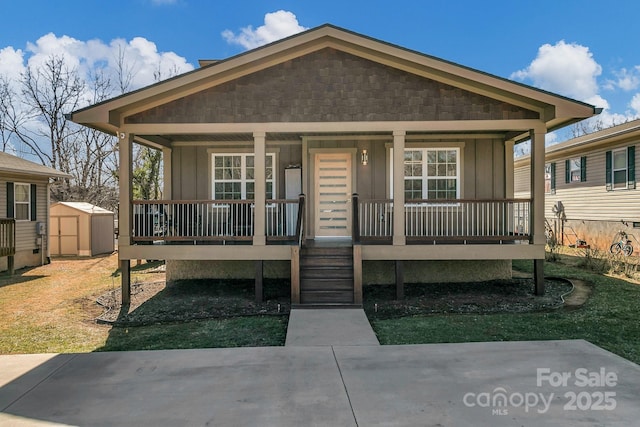 view of front of home featuring a shed and covered porch