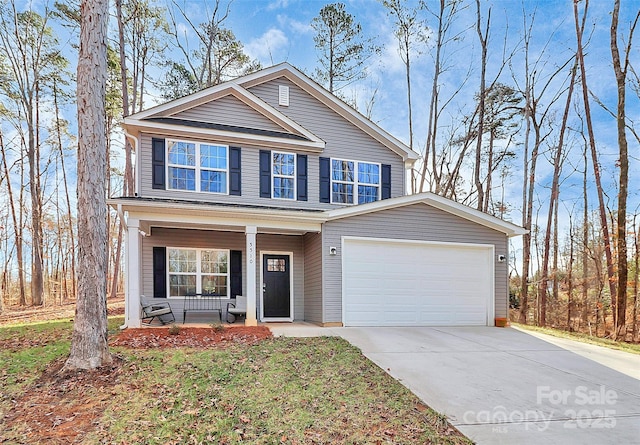 view of property featuring a garage and a porch