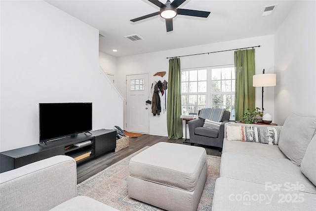 living room with hardwood / wood-style floors and ceiling fan