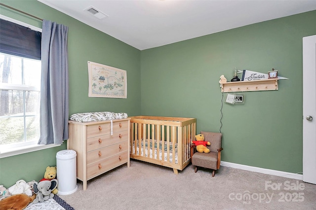 bedroom with light carpet and a crib