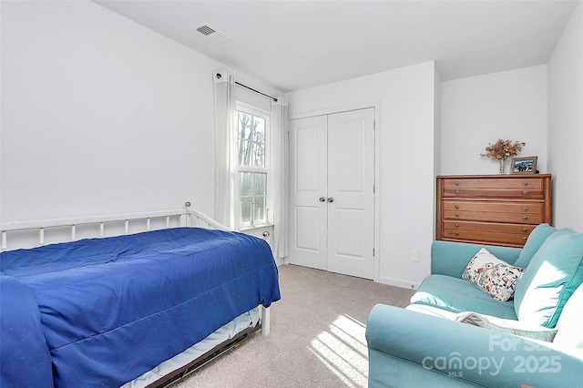 carpeted bedroom featuring a closet