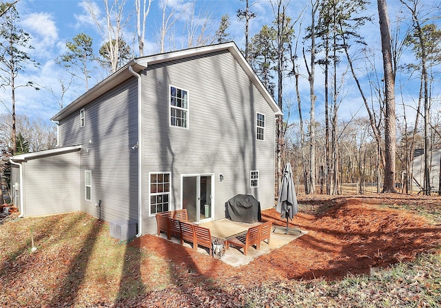 rear view of property featuring cooling unit and a patio area