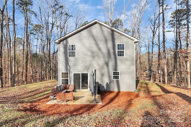 rear view of property featuring a patio area