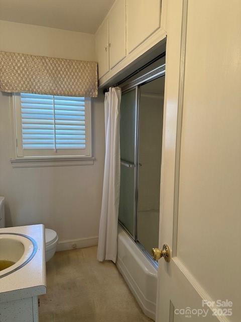 full bathroom featuring vanity, toilet, and combined bath / shower with glass door