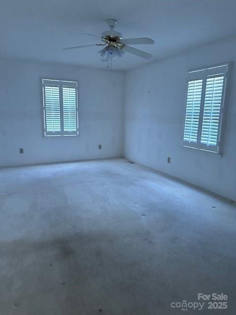 unfurnished room featuring concrete flooring and ceiling fan