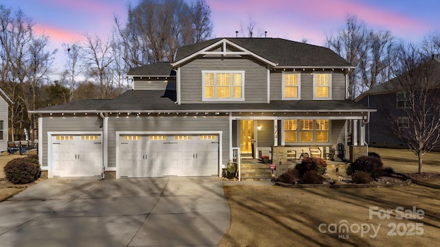 view of front of home featuring a garage and covered porch