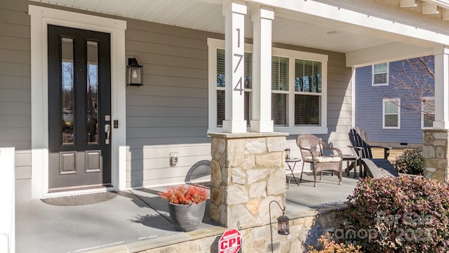 doorway to property featuring covered porch