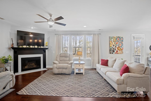 living room featuring hardwood / wood-style floors and ceiling fan