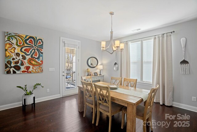 dining room featuring a chandelier and dark hardwood / wood-style flooring