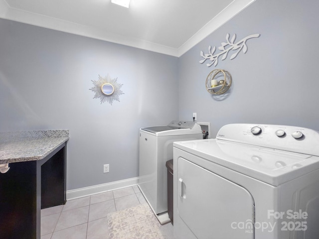 washroom featuring independent washer and dryer, ornamental molding, and light tile patterned floors