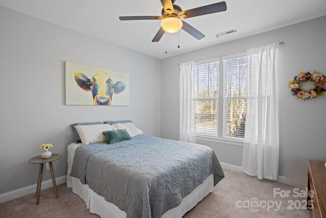 bedroom featuring ceiling fan and light colored carpet