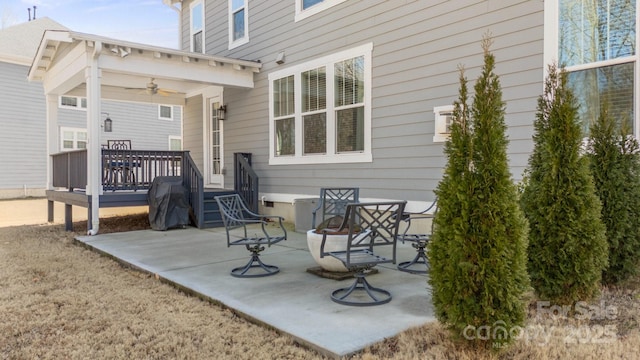 rear view of house with a wooden deck, ceiling fan, and a patio