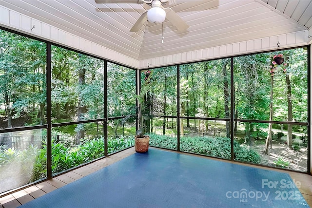 unfurnished sunroom with vaulted ceiling and ceiling fan