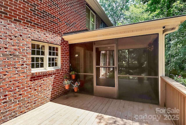 wooden terrace featuring a sunroom