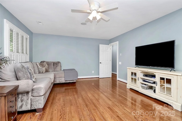 living room with ceiling fan and light wood-type flooring