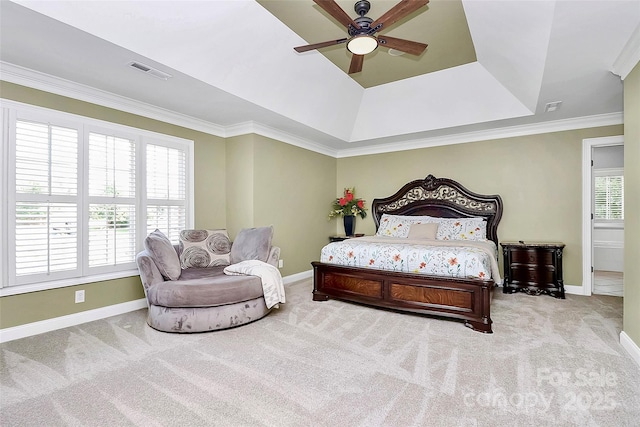 bedroom with light carpet, ceiling fan, and a tray ceiling