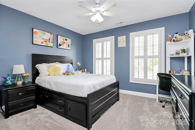 bedroom with ceiling fan and light carpet