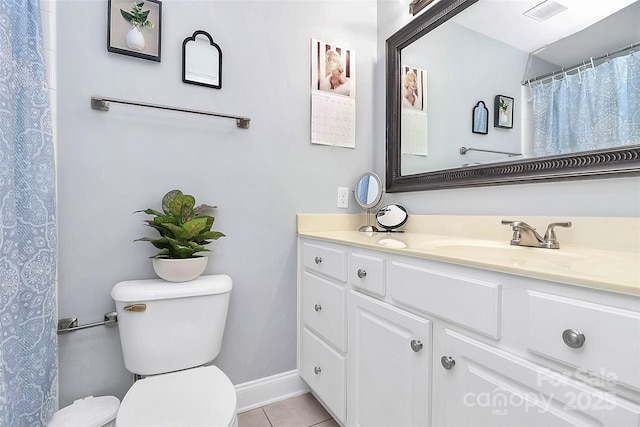 bathroom featuring vanity, tile patterned floors, and toilet