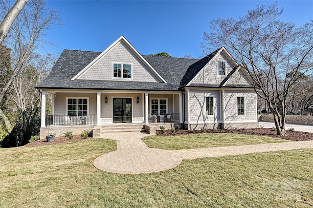 view of front of property featuring a front yard and covered porch