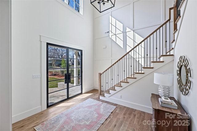 entrance foyer with light hardwood / wood-style floors and a high ceiling