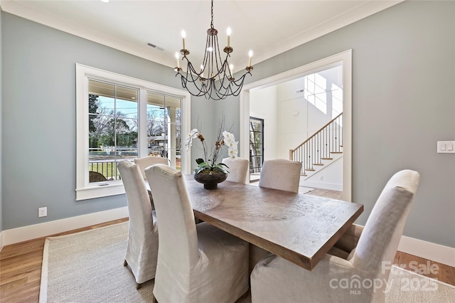 dining room featuring an inviting chandelier and light hardwood / wood-style flooring