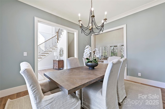 dining space featuring light hardwood / wood-style floors and a notable chandelier