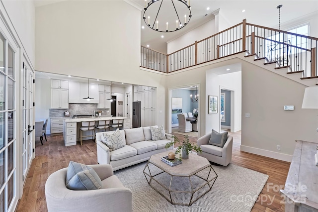 living room with a notable chandelier and light hardwood / wood-style flooring