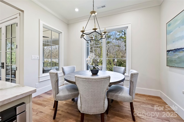 dining room featuring a notable chandelier and light hardwood / wood-style flooring