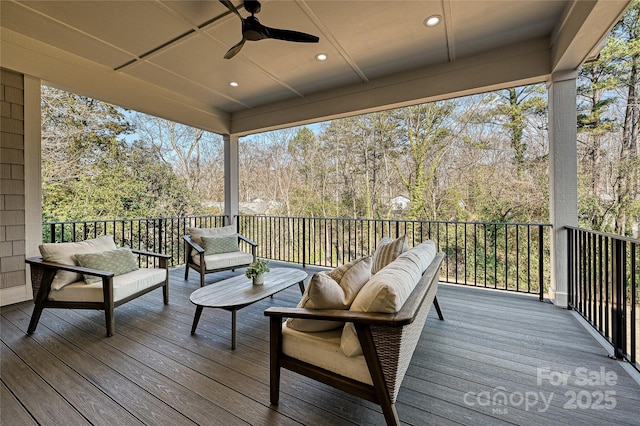 wooden deck featuring ceiling fan and outdoor lounge area