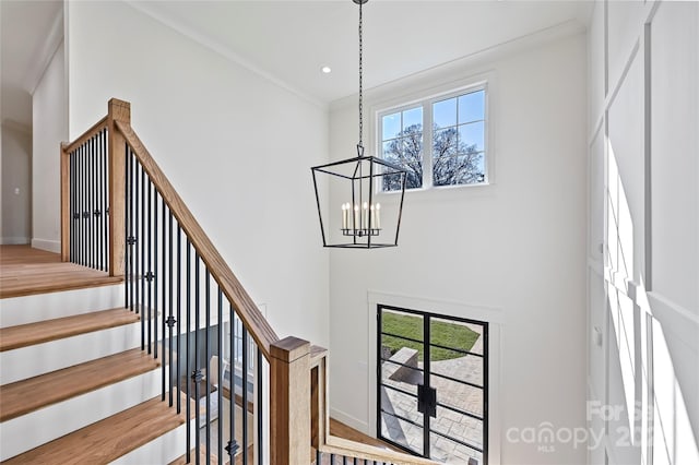 staircase with a high ceiling and an inviting chandelier