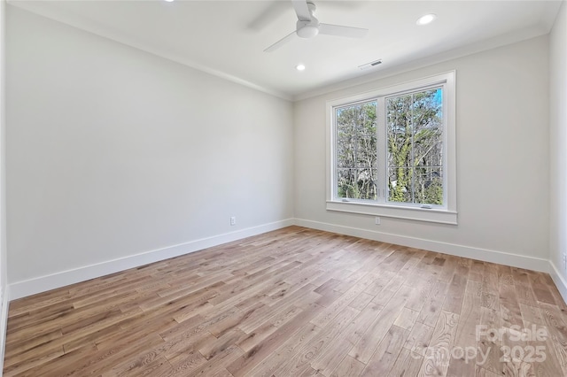 empty room with ceiling fan, ornamental molding, and light hardwood / wood-style floors