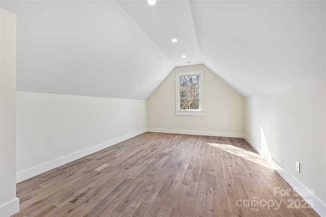 bonus room featuring vaulted ceiling and light wood-type flooring