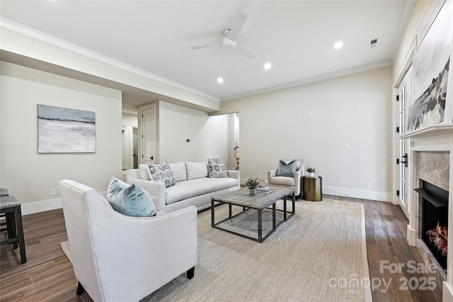 living room featuring crown molding, ceiling fan, and light wood-type flooring