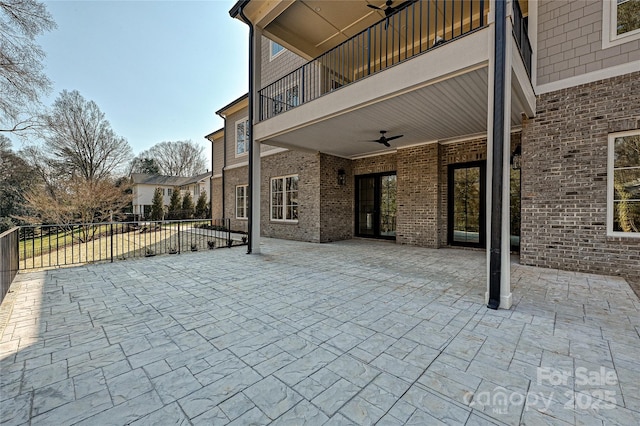 view of patio / terrace with a balcony and ceiling fan