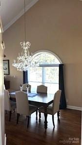 dining room featuring high vaulted ceiling, wood-type flooring, and ornamental molding