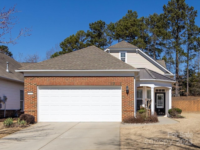 view of front of home featuring concrete driveway, brick siding, an attached garage, and roof with shingles