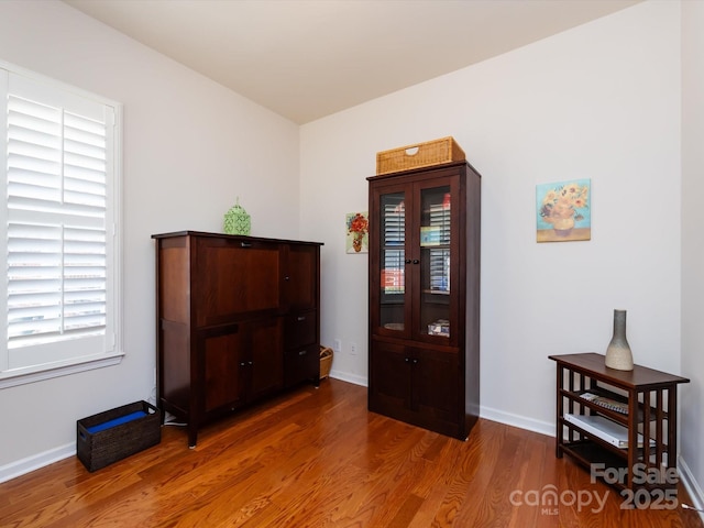 interior space featuring wood finished floors and baseboards