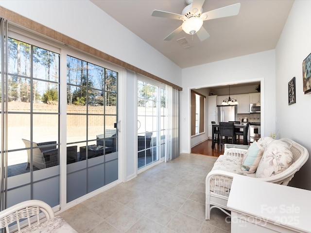 sunroom / solarium with visible vents and ceiling fan