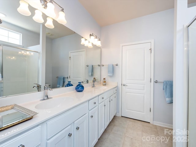 full bathroom with double vanity, tile patterned flooring, a sink, and a shower stall