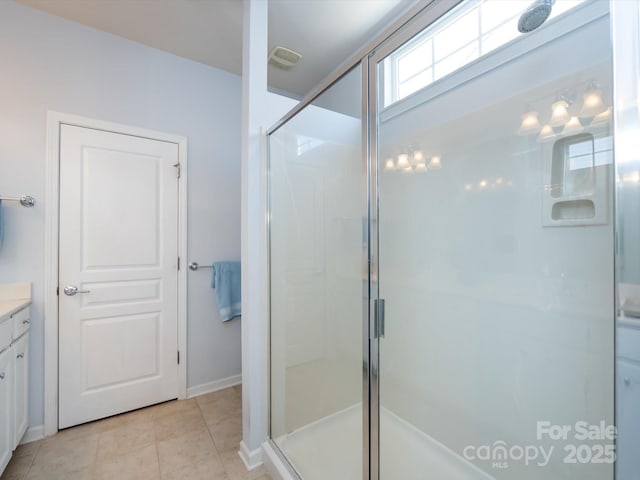 bathroom with a shower stall, vanity, and tile patterned floors