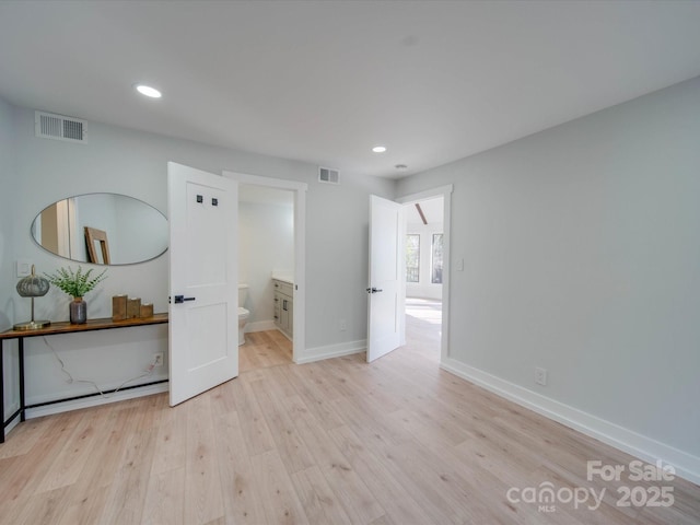 empty room with a baseboard radiator and light wood-type flooring