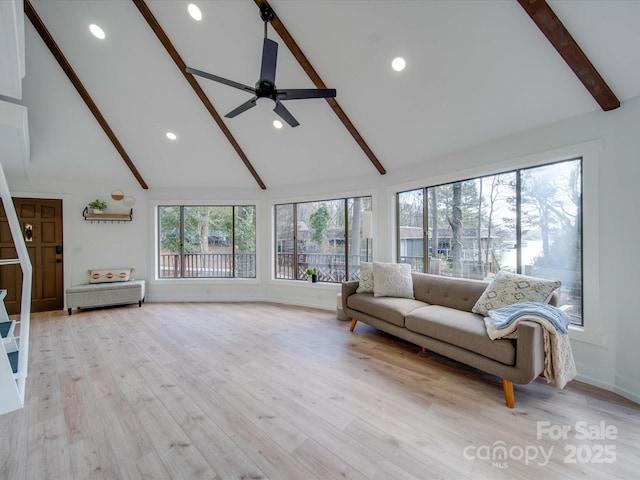 living room with high vaulted ceiling, beamed ceiling, light hardwood / wood-style floors, and ceiling fan