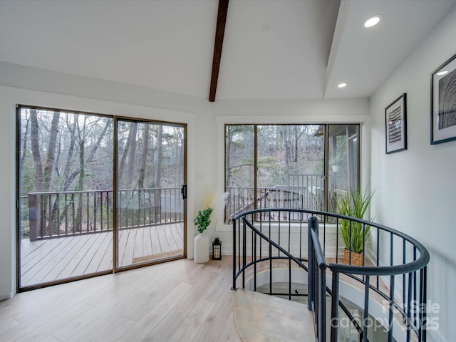 sunroom featuring lofted ceiling with beams