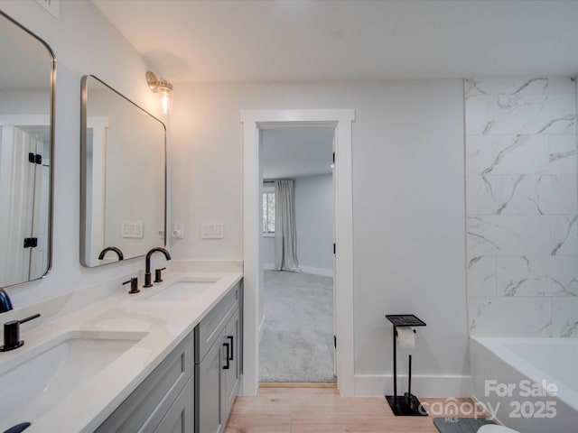 bathroom with vanity and hardwood / wood-style flooring