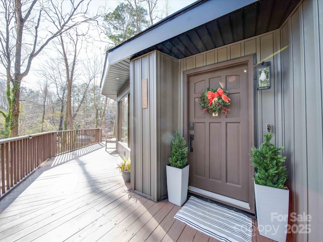 view of exterior entry with a wooden deck