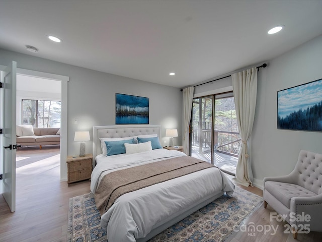 bedroom featuring light hardwood / wood-style flooring and access to outside