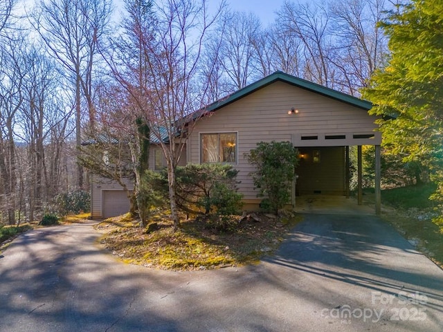 view of front of property featuring a carport and a garage